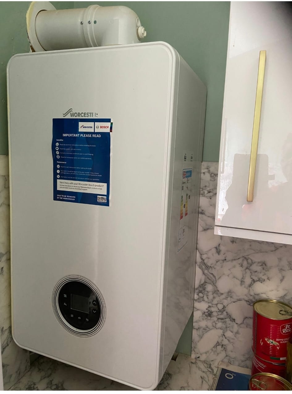 Worcester Bosch boiler installation on a marble-effect kitchen wall by DHP London.
