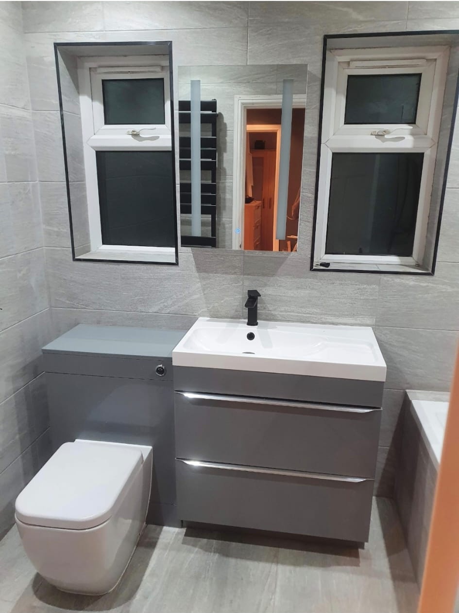 Grey double-drawer vanity and back-to-wall toilet installation in Dartford by DHP London.