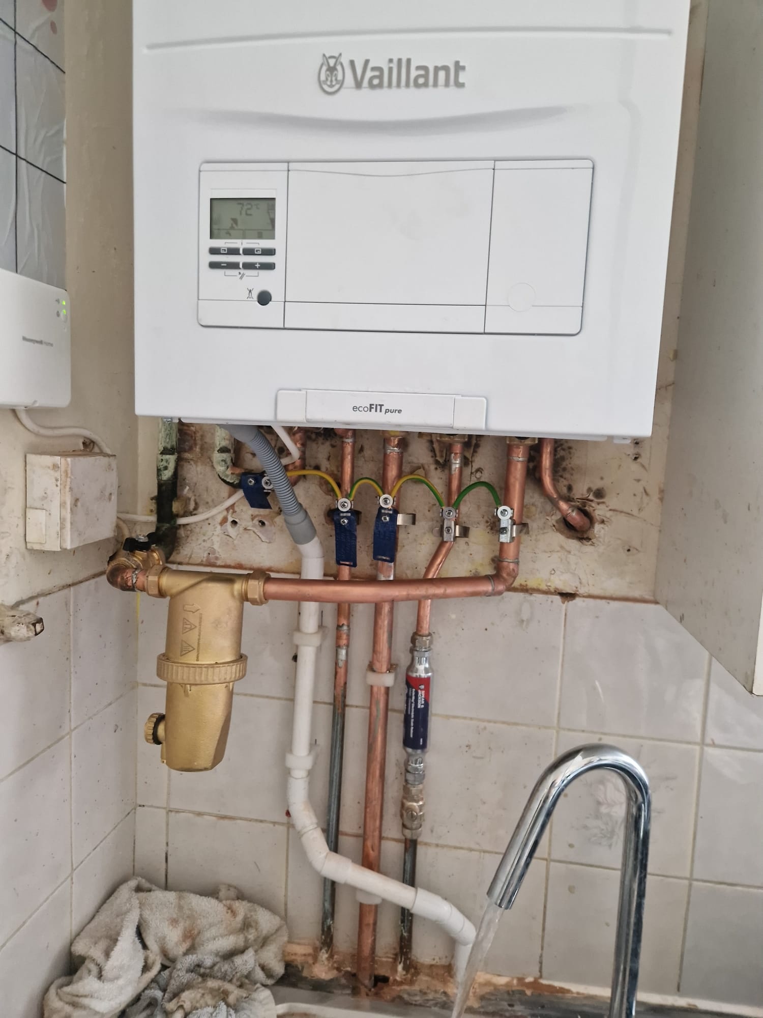 Vaillant boiler installation with brass filter in a Greenwich kitchen, Gas Safe registered.
